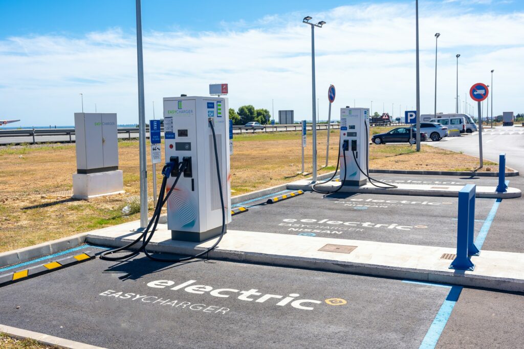 Electric car chargers at a gas station, with a parking space. ecological mobility