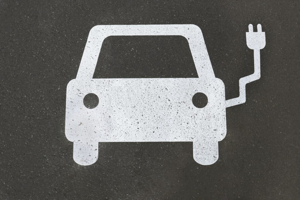 electric car charging station symbol painted on asphalt - e-mobility concept